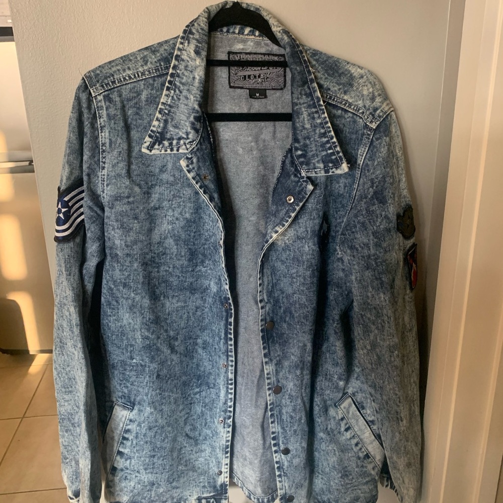 Acid wash Jean jacket with patches on the sleeve